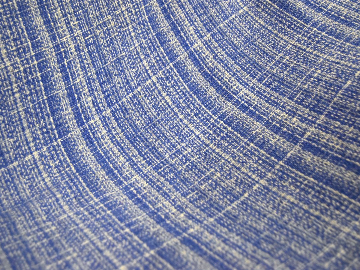 Close textile view showing weave, stitched edge, and soft folds