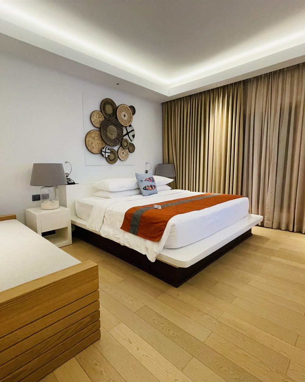Morning bedroom scene with layered bedding and natural light